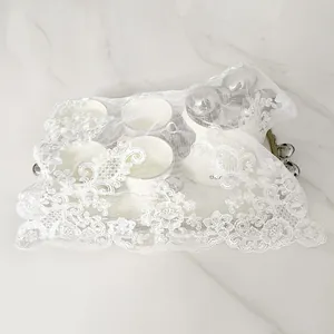 White embroidered lace dust cover cloth on tea set and marble table