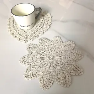 Detailed view of vintage beige crochet lace coasters in heart and floral mandala shapes