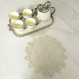 Detailansicht eines cremefarbenen Retro-Spitzendeckchens mit aufwendiger Lochstickerei