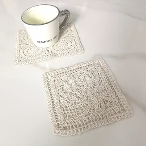 Close-up of vintage square crochet lace coaster with intricate cotton openwork detail
