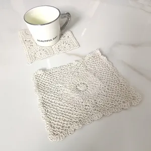 Macro view of a cream-colored vintage lace square cotton coaster with intricate crochet detail