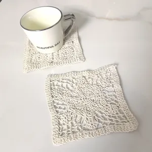 Detailed view of handmade vintage white cotton lace crochet square coasters