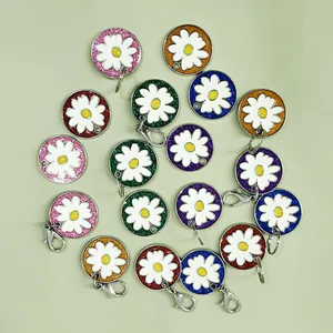 Close-up view of multiple colorful glitter daisy identity pet tags for dogs and cats