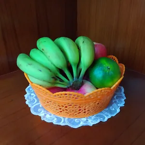 Detailed view of white circular embroidered lace coaster under a fruit basket.