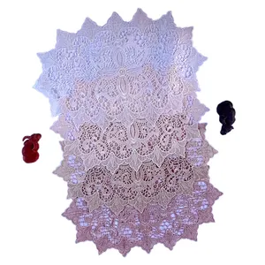 Set of elegant embroidered lace coasters with delicate hollow-out floral patterns.