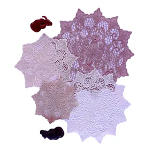 Detailed view of assorted European lace coasters with hollow-out floral embroidery.
