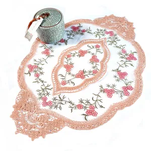 Gros plan sur l'élégante broderie florale et le bord en dentelle beige d'un set de table