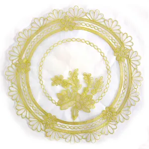 Detailed view of an elegant round lace placemat with gold floral embroidery