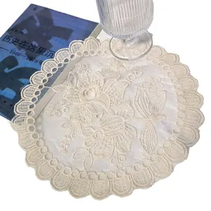 Round off-white lace embroidered placemat with floral patterns for elegant table decor