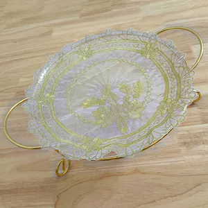 Detailed close-up of white European style round tray mat with golden floral lace embroidery