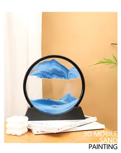 Close-up of blue 3D mobile sand painting with artistic mountain landscape effect.