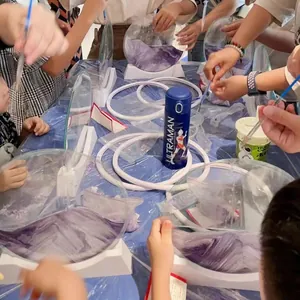 Detailed close-up of participants creating 3D quicksand paintings in a creative DIY workshop event