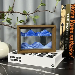 Blue 3D moving sand art in a premium wooden frame on a decorative bookshelf