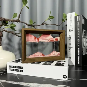 Close-up of a 3D moving sand art picture in a wooden frame for elegant home office decor.