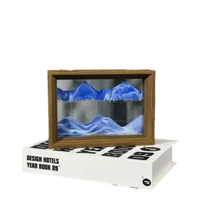 Elegant 3D moving sand art decoration in a natural wood frame with blue mountain scenery