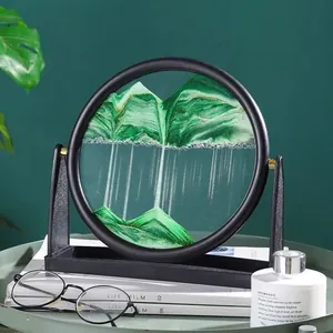 Creative moving sand art picture with green mountains in a circular black frame for desk decor