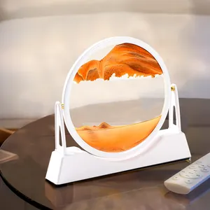 Decorazione artistica con sabbia mobile 3D, cornice bianca e sabbia arancione.