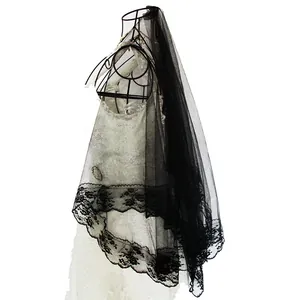 Close-up of vintage black mesh veil with delicate floral lace edging for stage