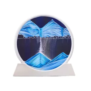 Circular 3D moving sand art ornament featuring blue and white landscape on white base