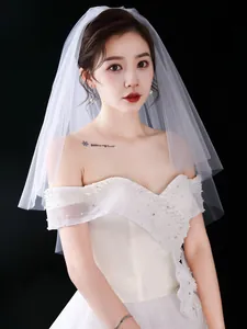 Detailed close-up showing the soft texture of a short white minimalist wedding bridal veil