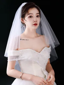 Detail showing the delicate texture of the white double-layer bridal wedding veil