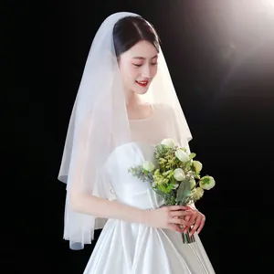 Close-up detail of an elegant short white bridal veil featuring a minimalist design