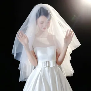 Detailed view of elegant multi-layered white tulle bridal veil with soft studio lighting