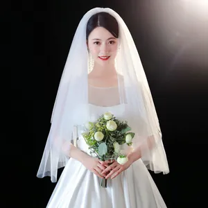 Elegant short white bridal veil made of soft sheer tulle with a minimalist design