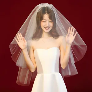 Elegant short white bridal veil with a multi-layer tulle design for wedding photos