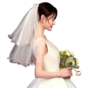 Simple double-layer white bridal veil with bow for wedding photos and ceremony