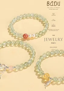 Detail view of beaded bracelets with freshwater pearls, pink crystals, and charms