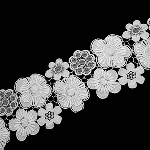 Detailed view of white water-soluble lace with double-layer floral embroidery patterns.