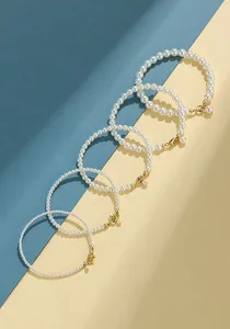 Elegant white pearl bead bracelet set in five different pearl sizes with gold clasps
