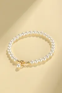 Minimalist pearl beaded bracelet with gold lobster clasp and drop pearl charm accessory