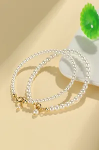 Detailed close-up showing texture of elegant beaded pearl bracelets with gold-plated clasps