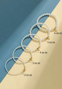 Detailed macro comparison of five pearl bracelet sizes ranging from 2mm to 6mm with labels