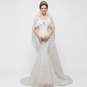 Long trailing bridal veil with elegant lace embroidery and glittering sequins