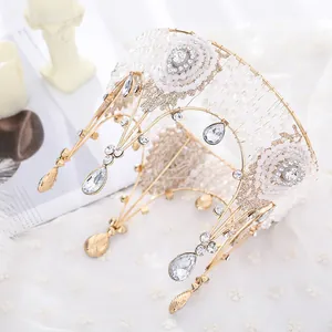 Close-up of handmade lace and beaded queen crown for wedding or cake topper.