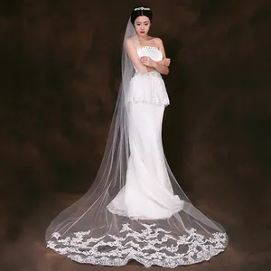 Elegant long bridal veil featuring exquisite white embroidered lace edge on dark backdrop