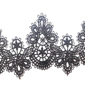 Close-up of black water-soluble lace trim with intricate hollow embroidery