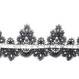 Detailed macro view of black water-soluble lace trim showing 10cm width measurement