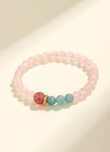 Vista macro di un bracciale con cristallo rosa e quarzo fragola