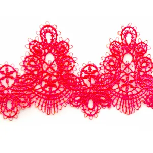 Detailed macro view of vibrant pink water-soluble lace trim with intricate embroidery