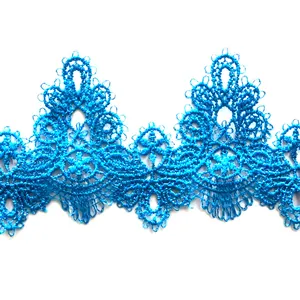 Macro close-up detail of blue water-soluble lace trim with floral embroidery pattern