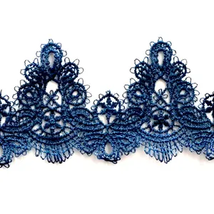 Detailed view of dark blue water-soluble lace trim with intricate floral embroidery
