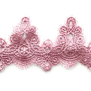Close-up of pink water-soluble lace trim with intricate 3D hollow embroidery pattern