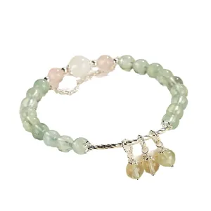 Freshwater pearl and prehnite beaded bracelet with rose quartz accents on white background