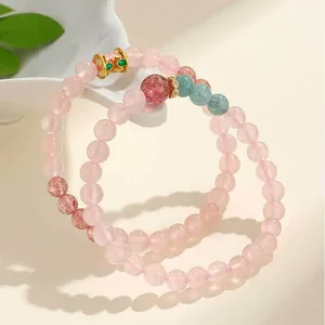 Eleganti bracciali con perline di quarzo rosa e cristallo fragola con dettagli in oro