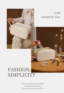 Detailed view of a large capacity cream leather travel cosmetic bag for toiletries.