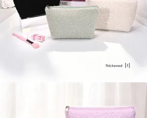Detail van de zachte sherpa textuur en de rits van de cosmetische tas.